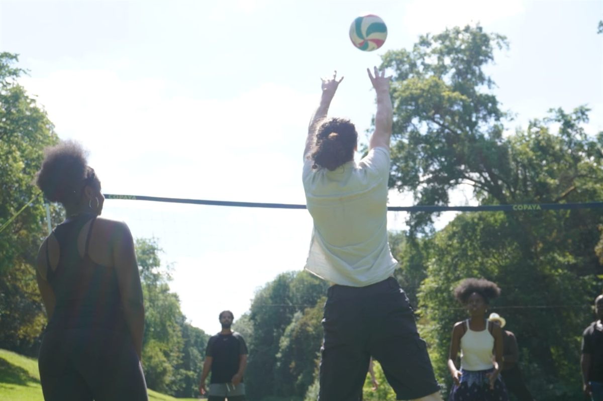 Thomas reaching for the ball on the volleyball court